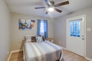 a bedroom with a bed and a ceiling fan at Charming Home 2 Mi to Downtown Memphis and Zoo in Memphis