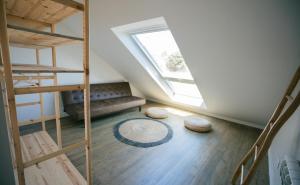 a room with a staircase and a couch and a window at Lapoint Surf Camp Ericeira in Ericeira