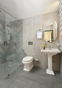 a bathroom with a toilet and a sink and a shower at The Sacred Lotus Ayurveda Wellness Retreat in Cochin