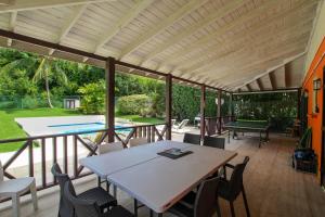 a patio with a table and chairs and a ping pong court at Chindwin 3 bedroom home in Saint Peter
