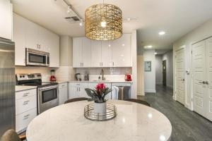 a kitchen with a table with a vase of flowers on it at Upscale Condos and Penthouses Close to Canal and Bourbon St in New Orleans