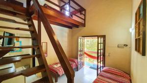 a room with a spiral staircase in a house at Hotel e Pousada Canto Mágico in Maresias +54 photos