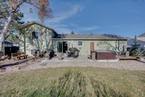 a large house with a patio and a yard at Loveland Home with Private Hot Tub and Wood Fireplace! in Loveland