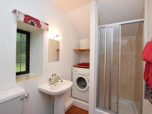 a bathroom with a sink and a washing machine at 1 bed property in Crackington Haven 36500 in Egloskerry