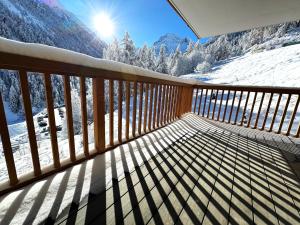 a balcony with a view of a snow covered mountain at Chalet Les Rahâs by Mrs Miggins in Grimentz