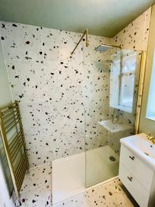 a bathroom with a shower with a glass door at Stunning house in Anfield, whole house in Liverpool