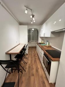 a kitchen with a table and chairs and a counter top at MEBA APARTMENTS in Braşov