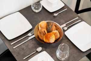 a bowl of bread sitting on top of a table at Hotel de Flore - Montmartre in Paris