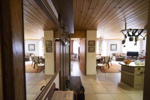 a hallway with a living room and a dining room at Chasa Serras - Döpper in Scuol