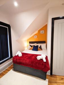 a bedroom with a bed with two towels on it at A&A Luxury Stay Alice in Sunderland