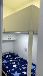 a bedroom with a bunk bed with stars on it at Decent Holiday Homes & Hostels near Burjuman Metro Station in Dubai