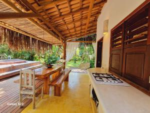 a kitchen with a table and a stove top oven at Mini Casa com Jacuzzi e Piscina in Trancoso