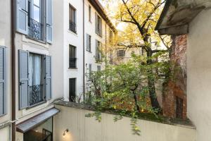 an apartment with a balcony in a building at MagnoliaApartments - 5 Nirone Center in Milan