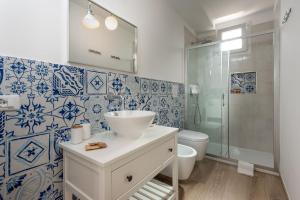 a bathroom with a toilet and a sink and a shower at I Tre Golfi - Appartamenti con Terrazzo in San Vito lo Capo