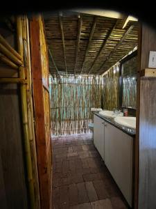 a bathroom with a sink and a tub at Sandton Safari Camp in Johannesburg