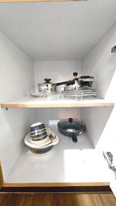 a shelf with a stove and a plate on it at Badri Homes in Pātan