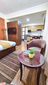 a living room with a bed and a coffee table at Badri Homes in Pātan