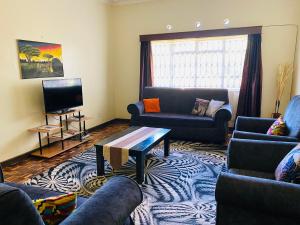 a living room with couches and a coffee table at Lisa place milimani in Kitale