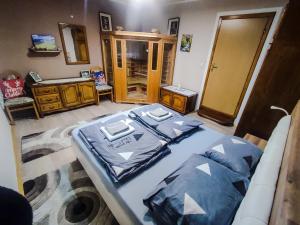 a bedroom with a large bed and a bathroom at Apartman Magic Sauna,Jakuzzi,Kino in Livno +8 photos