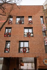 a red brick building with windows with flowers in them at 26Bricks Luxury Suites in Oradea