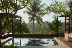 a villa with a pool and a view of the jungle at The Ridge Bali in Ubud