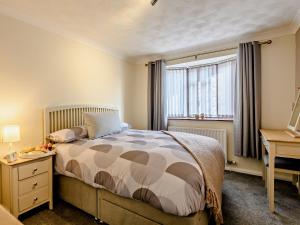 a bedroom with a bed and a desk and a window at 2 bed in Sutton-on-Sea 80703 in Sutton on Sea