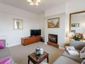 a living room with a couch and a fireplace at 2 bed in Bexhill on Sea 82747 in Sidley