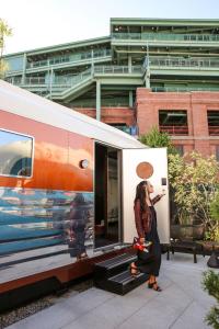 a woman is taking a picture of a train at The Verb Hotel in Boston