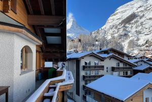 a view from the balcony of a building with snow at Haus Tiefbach - Apartment Cervino in Zermatt