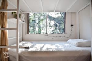 a bedroom with a bunk bed and a window at CoCoCo in Ko Phayam