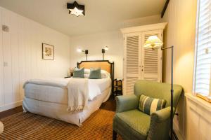 a bedroom with a bed and a chair at Hill Farm Inn - Manchester in Sunderland