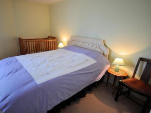 a bedroom with a large bed and two chairs at 3 bed in Minehead TRINI in Minehead