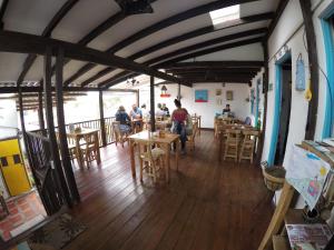 a group of people sitting at tables in a restaurant at Casa La Eliana in Salento