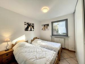 a bedroom with two beds and a window at Appartement Chamonix-Mont-Blanc, 4 pièces, 6 personnes - FR-1-507-74 in Chamonix