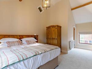 a bedroom with a large bed and a window at 5 Bed in Grindon 79543 in Grindon