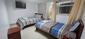 Een bed of bedden in een kamer bij HOTEL TICLIO