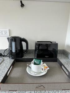 a box with a cup of coffee on a plate at Fitz Roy Hostería de Montaña - El Chaltén in El Chalten