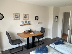 um quarto com uma mesa e duas cadeiras e uma cama em Huus Waterkant Wohnung 4 Feeringienwening em Wittdün