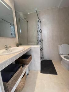 a bathroom with a sink and a toilet at Horizonte Azul in Calpe +15 photos