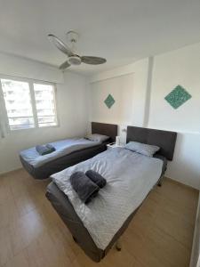 a bedroom with two beds and a ceiling at Horizonte Azul in Calpe