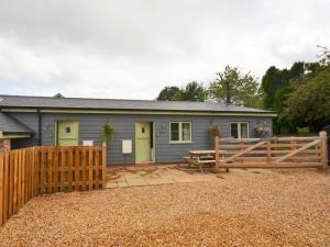 a house with a wooden fence and a picnic table at 2 Bed in Croes-y-pant 58962 in Mamhilad