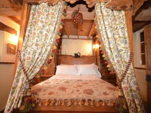 a bedroom with a canopy bed with curtains at 4 Bed in Corfe Mullen THOLD in Corfe Mullen