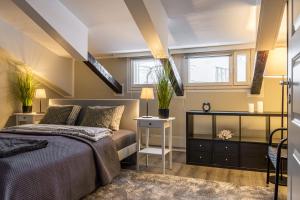 1 dormitorio con cama, mesa y ventanas en Hamina Bastion Apartments, en Hamina