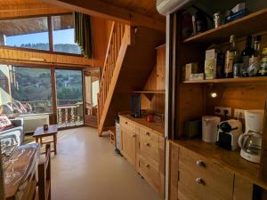 a kitchen with wooden cabinets and a dining room at Appartement La Clusaz, 3 pièces, 6 personnes - FR-1-459-223 in La Clusaz