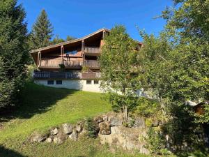 a house on top of a hill with trees at Appartement La Clusaz, 3 pièces, 6 personnes - FR-1-459-223 in La Clusaz