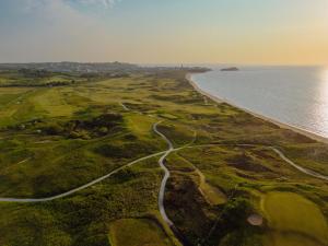 an aerial view of a golf course next to the ocean at The Dormy House in Tenby