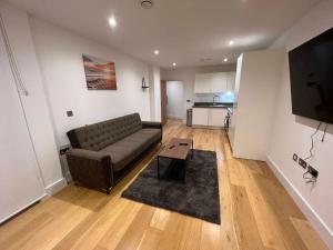 a living room with a couch and a table at Impeccable 2-Bed Apartment in Erith in Erith