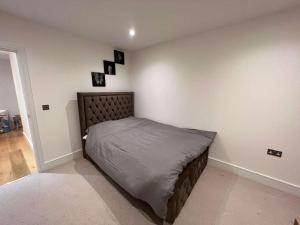 a bedroom with a bed in the corner of a room at Impeccable 2-Bed Apartment in Erith in Erith