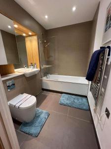 a bathroom with a toilet and a tub and a sink at Impeccable 2-Bed Apartment in Erith in Erith