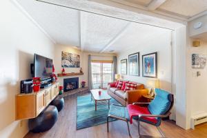 a living room with a couch and a tv at Rockies Condo 2407 in Steamboat Springs